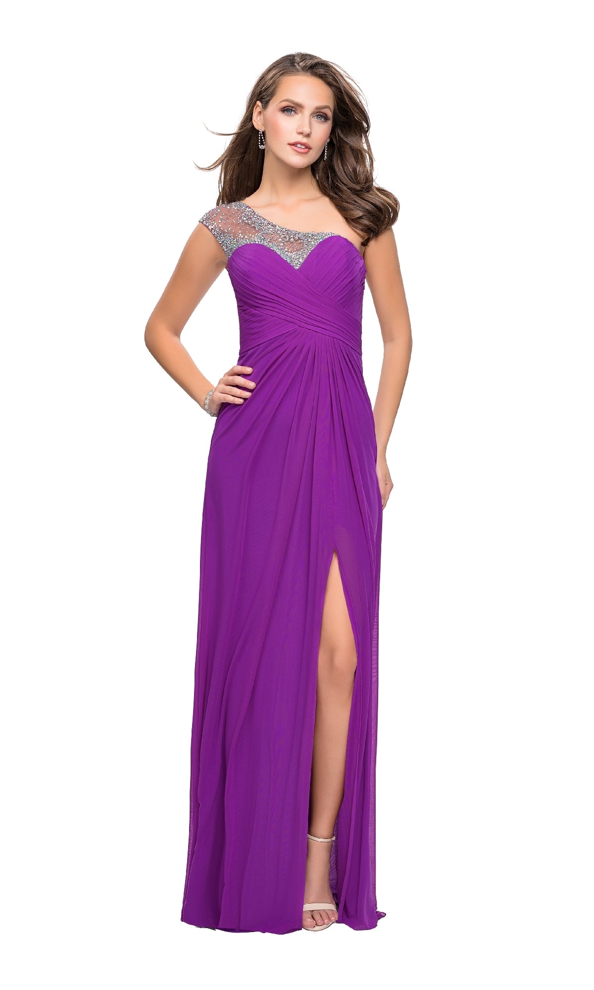 A woman in the La Femme 20384 one-shoulder long prom dress—a purple floor-length gown with a jeweled neckline and thigh-high slit—stands against a white background.